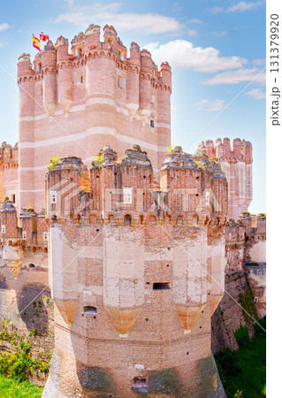 Coca castle showing spanish flag waving in the wind on sunny day Coca castle showing spanish flag waving in the wind on sunny day 131379920