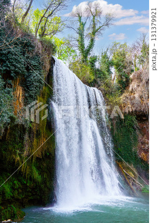 Waterfall cascading into turquoise pond at monasterio de piedra natural park 131379921