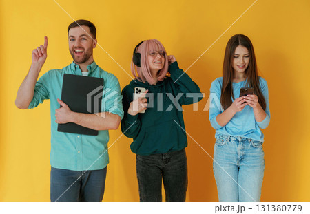 With technology. Group of friends are in the studio against background With technology. Group of friends are in the studio against background 131380779