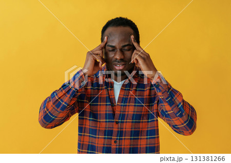Cafe worker. Black man is in the studio against yellow background 131381266