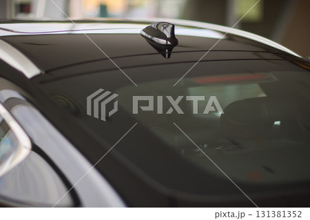 A detailed closeup view of the Car Roof Antenna positioned on a sleek, dark vehicle A detailed closeup view of the Car Roof Antenna positioned on a sleek, dark vehicle 131381352