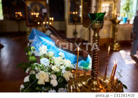 An Elegant Candle Holder featuring Lit Candles within a Beautiful and Serene Setting 131381410