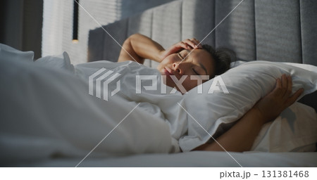 Young Woman Wakes Up Early in Morning In Bedroom 131381468
