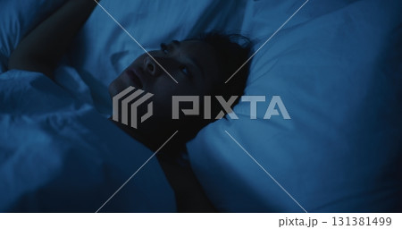 Young Woman Lies Awake at Night, Unable to Sleep Young Woman Lies Awake at Night, Unable to Sleep 131381499