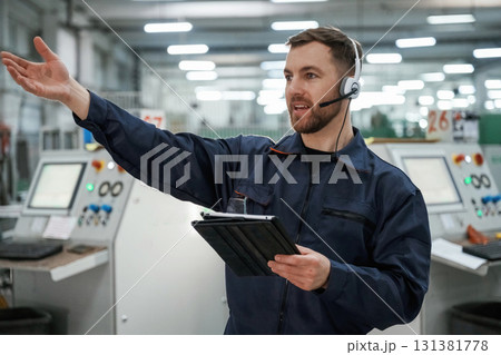Portrait of factory worker that is indoors with headphones 131381778