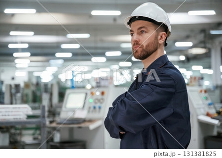 Smart employee. Factory worker is indoors with hard hat 131381825