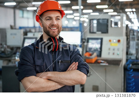 Front view. Factory worker is indoors with hard hat Front view. Factory worker is indoors with hard hat 131381870