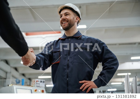 Doing handshake. Man on the factory is making deal with other person Doing handshake. Man on the factory is making deal with other person 131381892