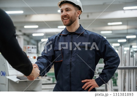Doing handshake. Man on the factory is making deal with other person Doing handshake. Man on the factory is making deal with other person 131381893