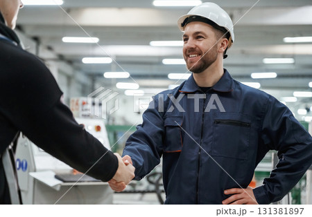 Doing handshake. Man on the factory is making deal with other person Doing handshake. Man on the factory is making deal with other person 131381897