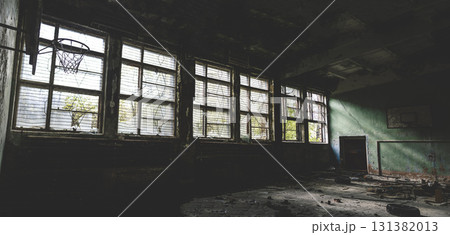 Gym at school.Old basketball hoop. Old windows.Horror concept. window silhouette. Scary bars on the windows. Panorama. Gym at school.Old basketball hoop. Old windows.Horror concept. window silhouette. Scary bars on the windows. Panorama. 131382013