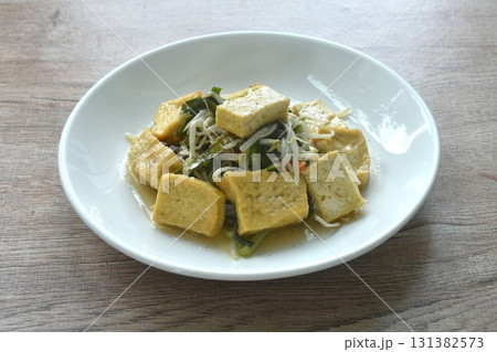 fried bean sprout and garliv chive with slice yellow tofu vegetarian food on plate  131382573