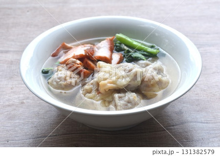 Chinese dumpling topping slice red barbecue pork with clear soup on bowl 131382579