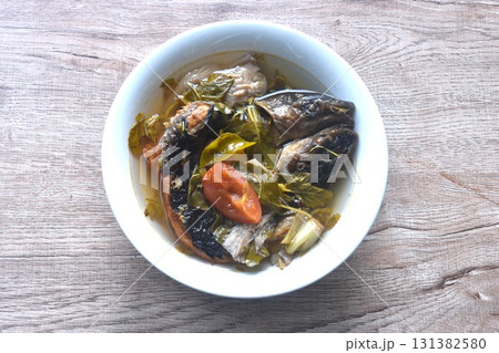 boiled smoked dry snake head fish with tamarind leaf in spicy and sour soup on bowl 131382580