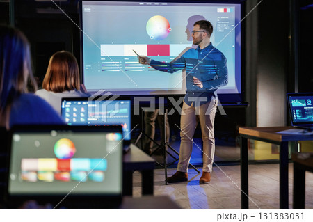 Design tools. Male business trainer is against projector with data, teaching people Design tools. Male business trainer is against projector with data, teaching people 131383031