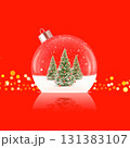 Christmas ball ornament with snowy trees inside on red background. Stock photo. 131383107