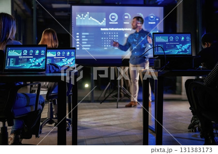 In formal clothes. Male business trainer is against projector with data, teaching people 131383173