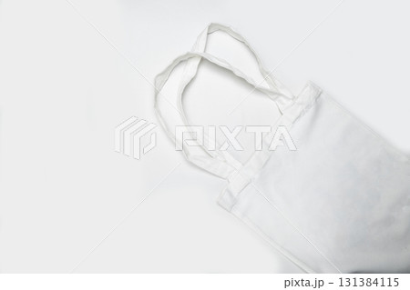 Top view of an eco-friendly white cotton canvas tote bag on a white background. Mockup, template, or copy space. Reusable bag for groceries and shopping Top view of an eco-friendly white cotton canvas tote bag on a white background. Mockup, template, or copy space. Reusable bag for groceries and shopping 131384115