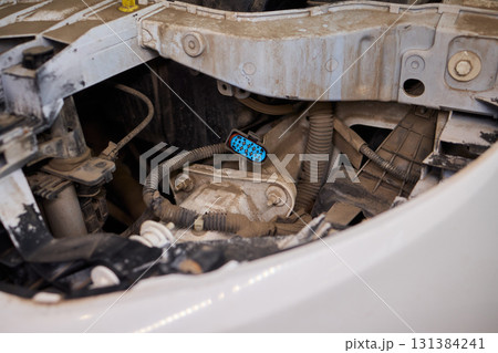 Closeup view of intricate car engine components and the important fluid reservoir Closeup view of intricate car engine components and the important fluid reservoir 131384241
