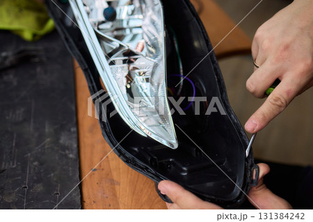 Careful precision is essential when installing a car headlight assembly for optimal performance 131384242