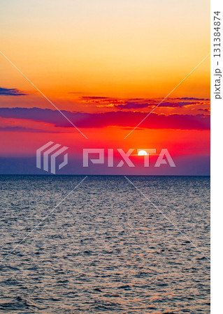 setting sun over sea at sunset 131384874
