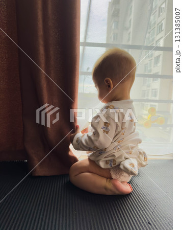 Baby in Pajamas Looking Out the Window Baby in Pajamas Looking Out the Window 131385007