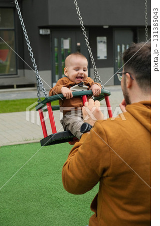 Father and Baby Enjoying Swing Time Father and Baby Enjoying Swing Time 131385043