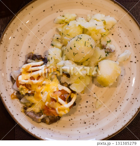 French meat with boiled potatoes served on plate. top view 131385279