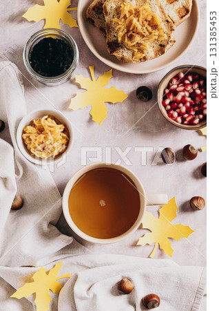 A cup of tea and autumn toast with apple jam on a plate on the table top and vertical view A cup of tea and autumn toast with apple jam on a plate on the table top and vertical view 131385453
