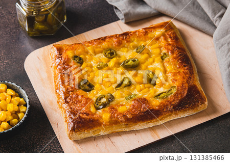 Traditional Mexican pizza with jalapenos, cheese and corn on a board on the table Traditional Mexican pizza with jalapenos, cheese and corn on a board on the table 131385466