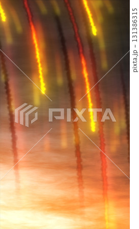 Glowing red and yellow light streaks descend against a smoky background, resembling fiery trails in the sky Glowing red and yellow light streaks descend against a smoky background, resembling fiery trails in the sky 131386315