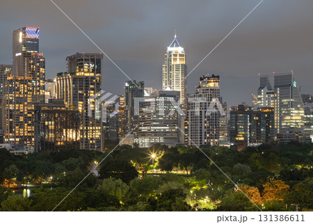 the illuminated high-rise buildings and skyscrapers of Bangkok city at night. 131386611