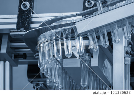 Close up scene the plastic bottle preform shape on the conveyor belt in the blue scene Close up scene the plastic bottle preform shape on the conveyor belt in the blue scene 131386628