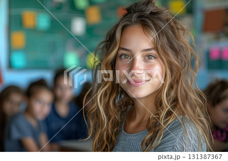Girl with long brown hair is smiling at the camera in the school office Girl with long brown hair is smiling at the camera in the school office 131387367