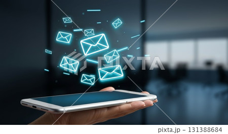 Hand holding smartphone with glowing email icons representing digital marketing concepts Hand holding smartphone with glowing email icons representing digital marketing concepts 131388684