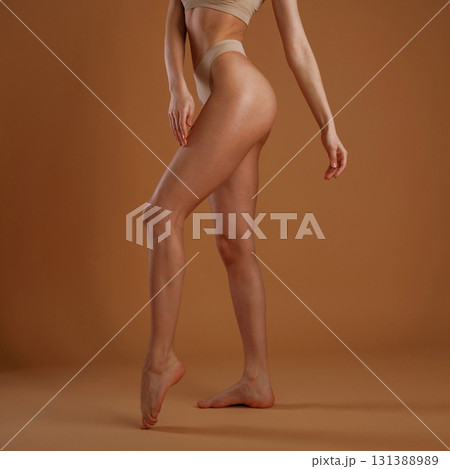 Close up view. Woman with slim body shape is posing against background Close up view. Woman with slim body shape is posing against background 131388989