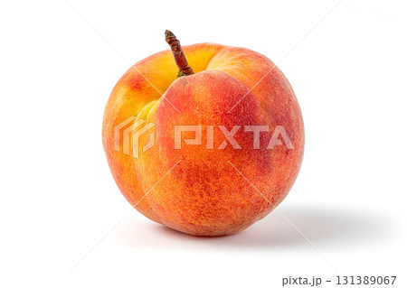 A ripe peach sits alone on a white background, showing its vibrant colors. 131389067