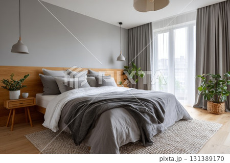 Cozy bedroom with natural light, plants, and soft textures for sleep tourism concept 131389170