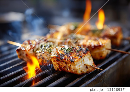 Blue Marlin Swordfish skewers grilling over flames with vibrant colors and smoky atmosphere Blue Marlin Swordfish skewers grilling over flames with vibrant colors and smoky atmosphere 131389574