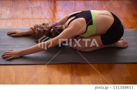 Teenage girl stretching and relaxing at home. Natural light 131389651