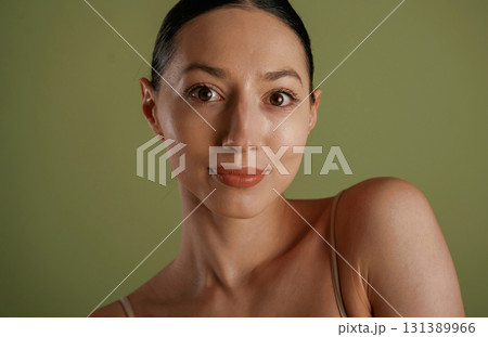 Portrait of woman that is posing against background 131389966