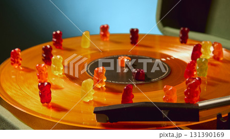 Close up of gummy bears on spinning vinyl record with nostalgic lifestyle charm 131390169