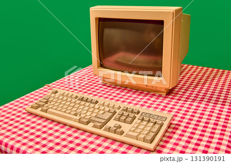 Retro beige computer monitor and keyboard on checkered table 131390191