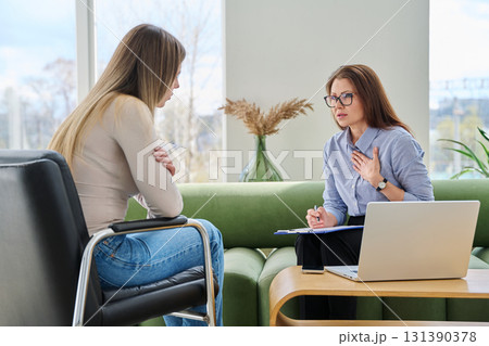 Female counselor psychologist working with young woman patient Female counselor psychologist working with young woman patient 131390378