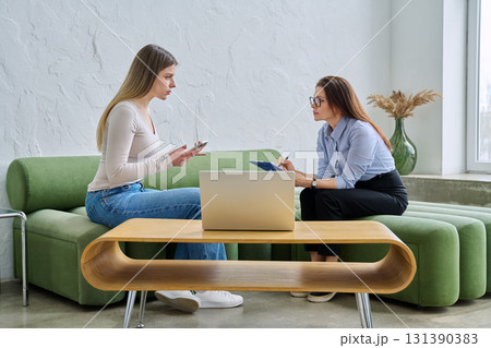 Young female patient during psychotherapy session with psychologist Young female patient during psychotherapy session with psychologist 131390383