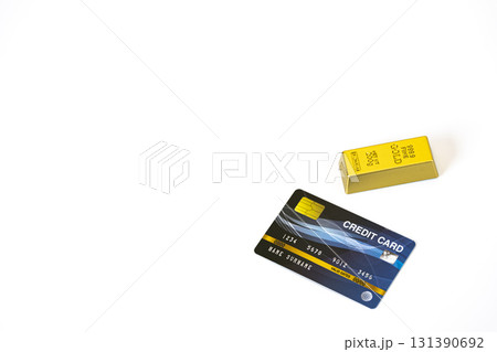 Credit card and gold bar are placed on white background, symbolizing wealth and financial concepts with ample copy space Credit card and gold bar are placed on white background, symbolizing wealth and financial concepts with ample copy space 131390692