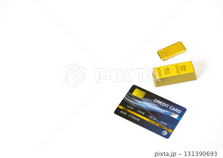 Credit card and gold bars on white background symbolize wealth and financial security. image conveys sense of luxury and prosperity with ample copy space 131390693