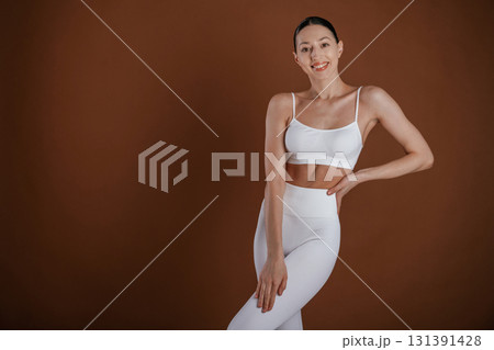Front view. Beautiful fitness woman is in the studio Front view. Beautiful fitness woman is in the studio 131391428