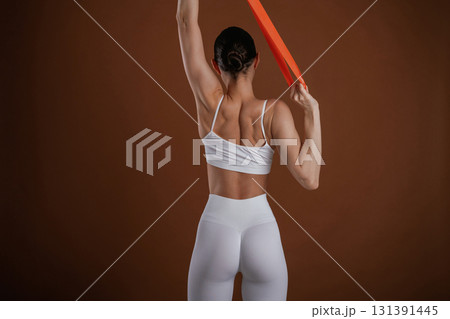 Stretching the hands. Beautiful fitness woman is in the studio 131391445