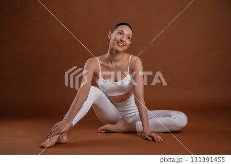 Female, front view, smiling. Beautiful fitness woman is in the studio Female, front view, smiling. Beautiful fitness woman is in the studio 131391455